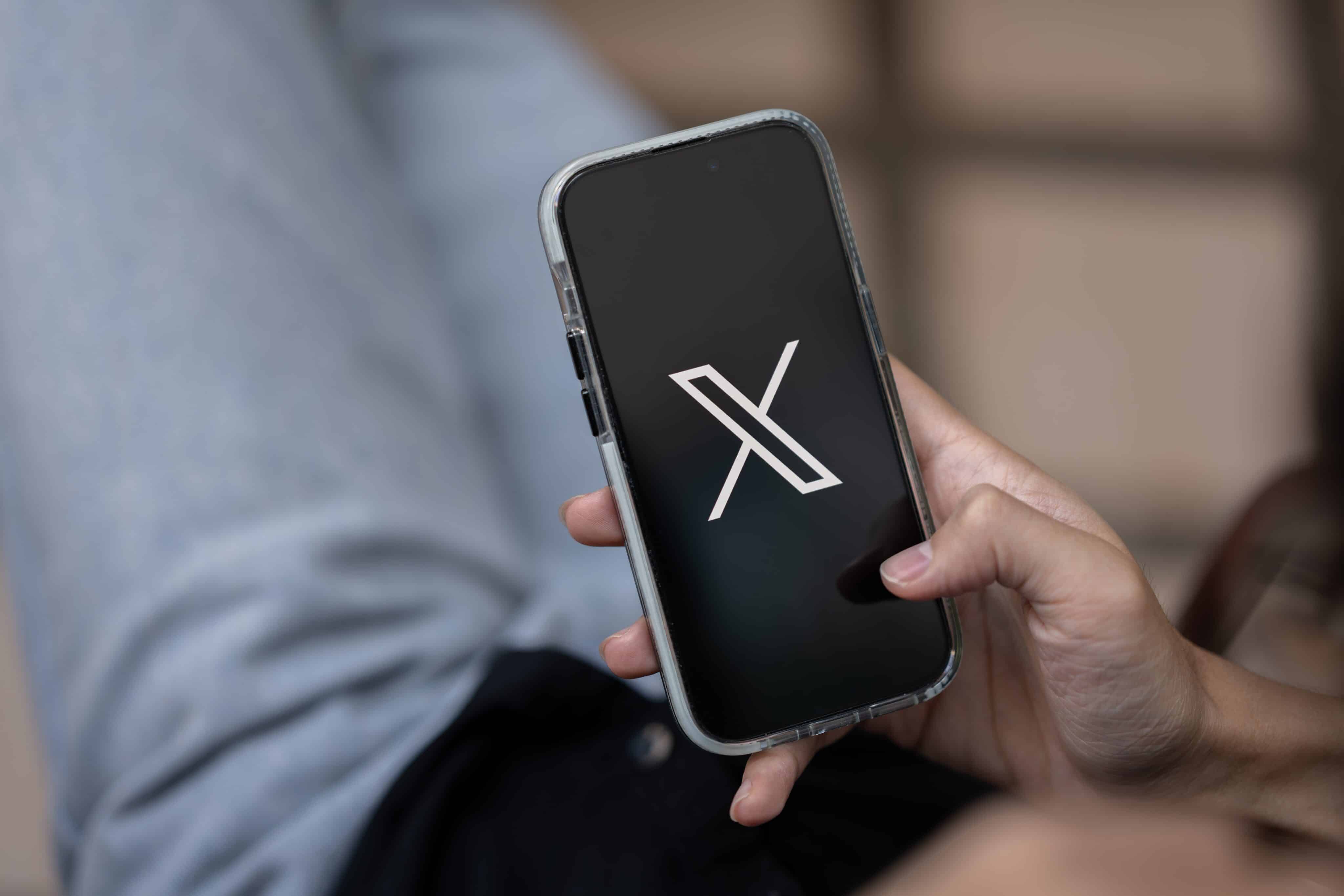 Hombre usando X en un iPhone